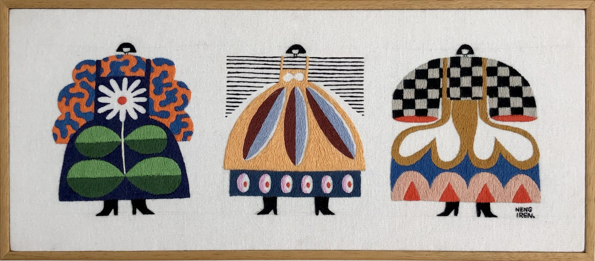 an embroidered artwork by Irene Saputra of three colorful, patterned, symmetrical, abstractly shaped figures