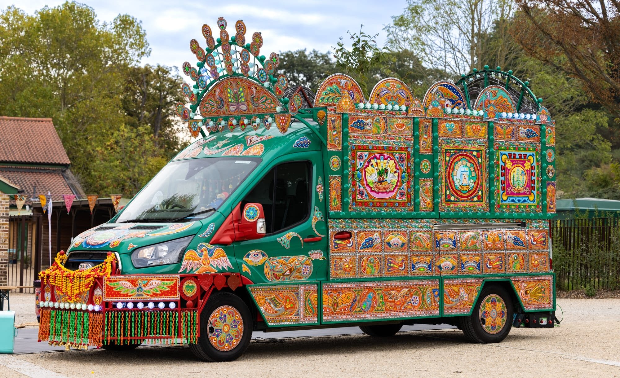 a side view of a colorful van that has been transformed into an artwork