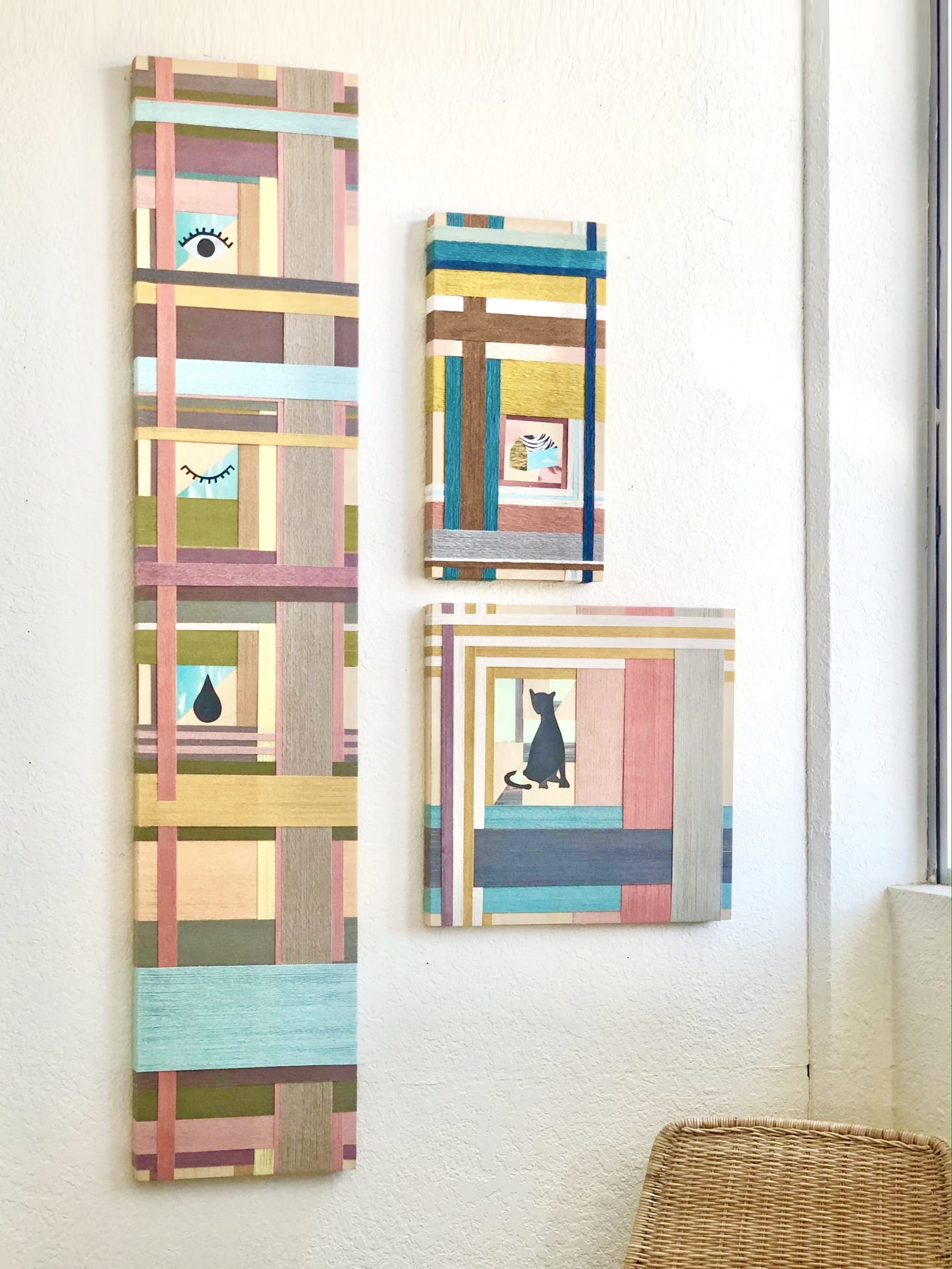 three pieces by Natalie Ciccoricco installed on a wall, featuring collaged paper and bands of wrapped thread