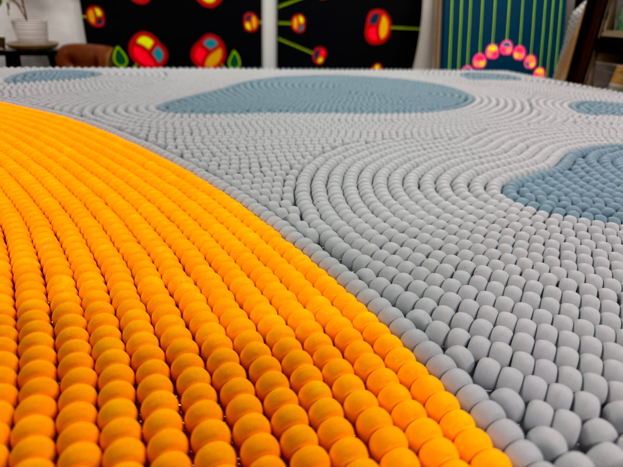 a detail image of a blue and yellow beaded work by Renee Condo