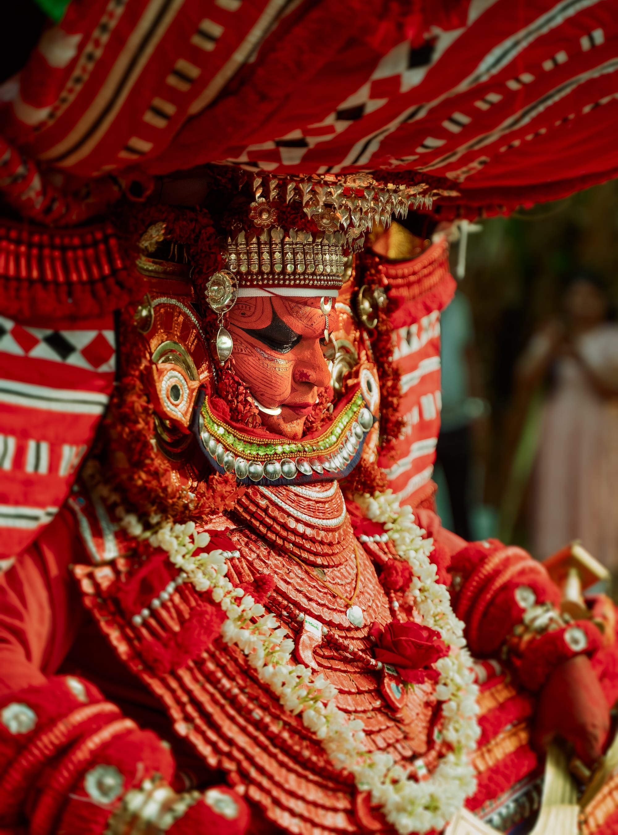 a photograph by Navneet Jayakumar of an elaborate ceremonial outfit worn by a performer for Theyyam, in Kerala, India