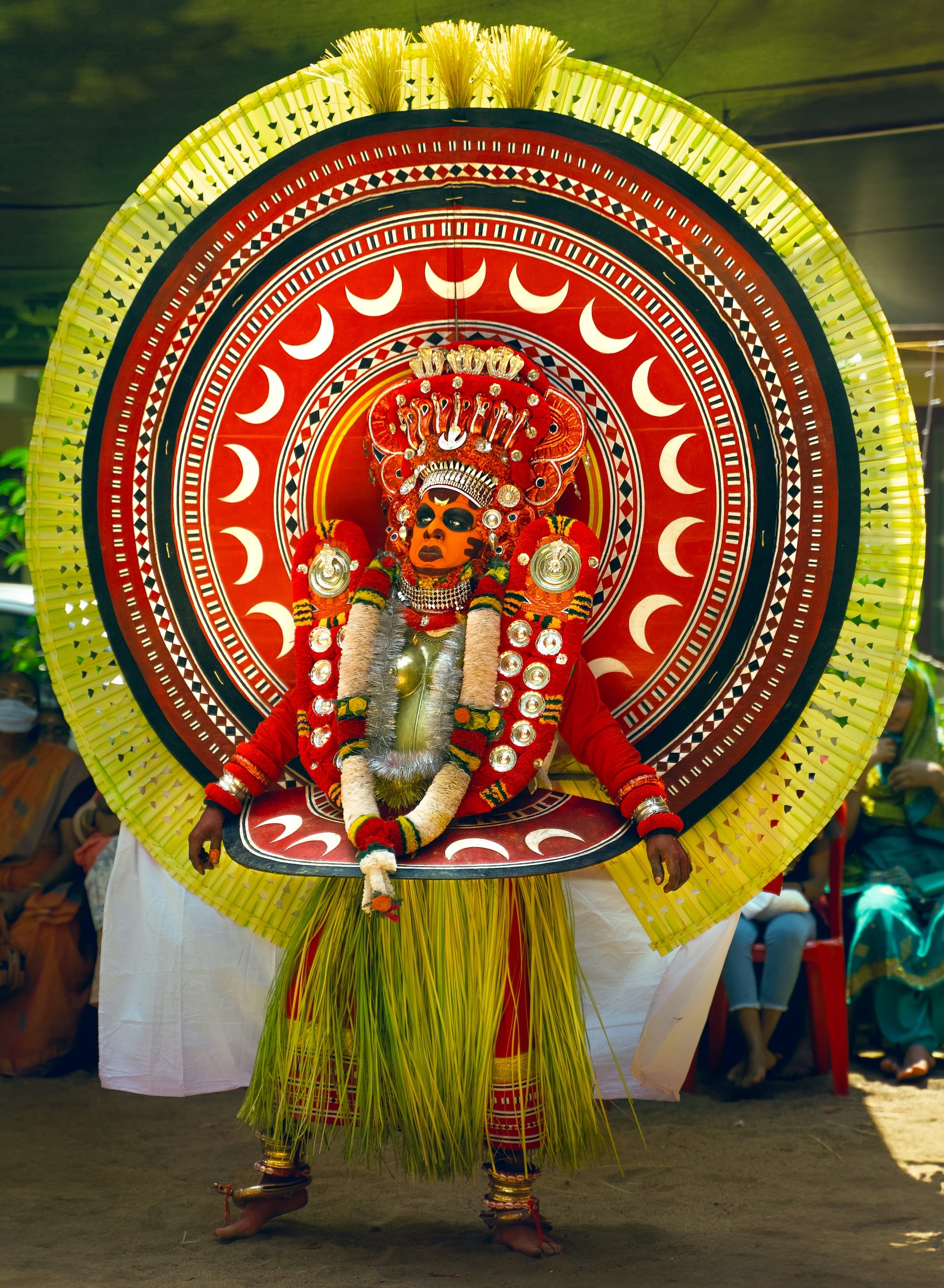 a photograph by Navneet Jayakumar of an elaborate ceremonial outfit worn by a performer for Theyyam, in Kerala, India