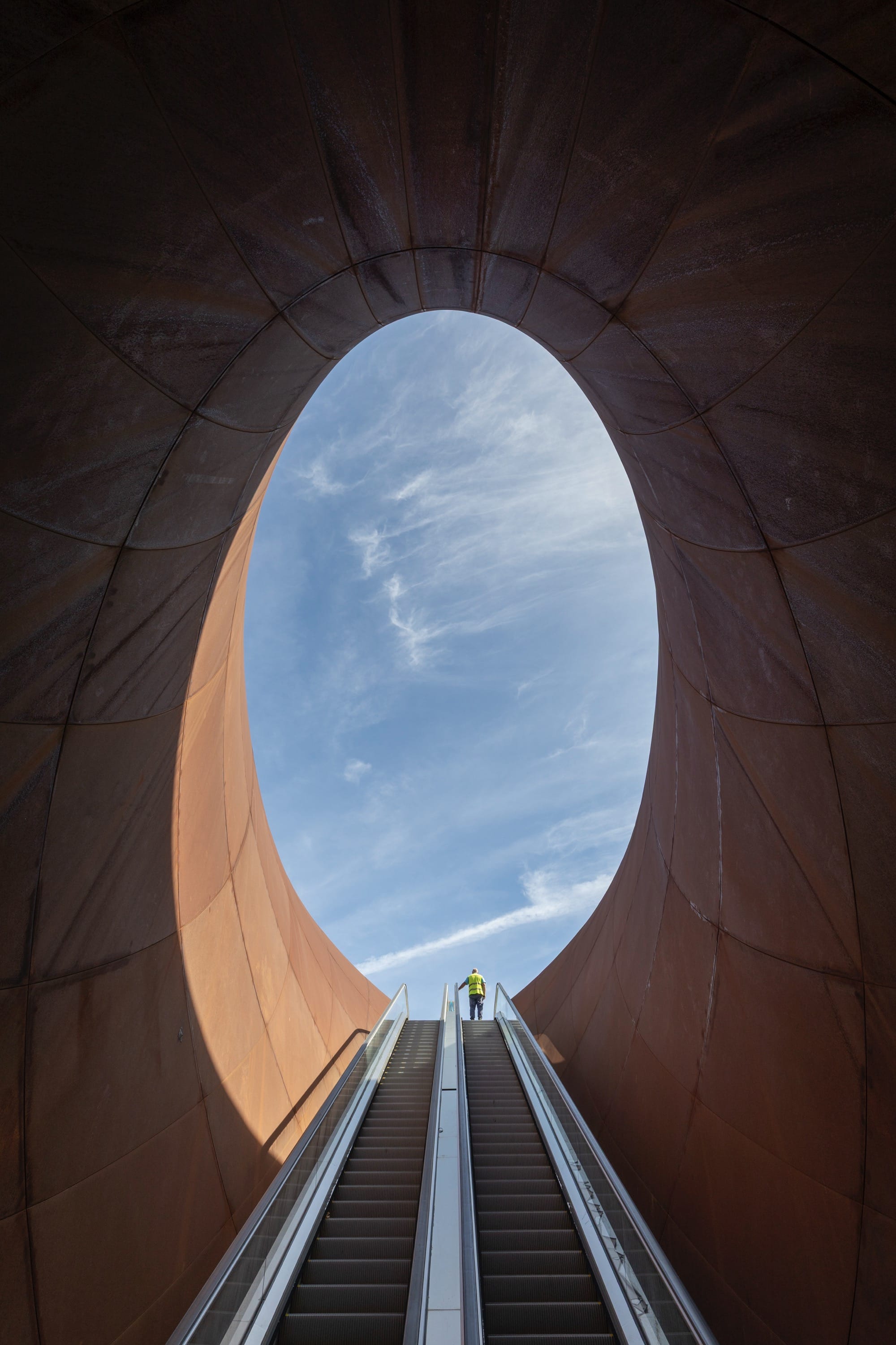escalators leading up from a contemporary train station in Naples designed by Anish Kapoor