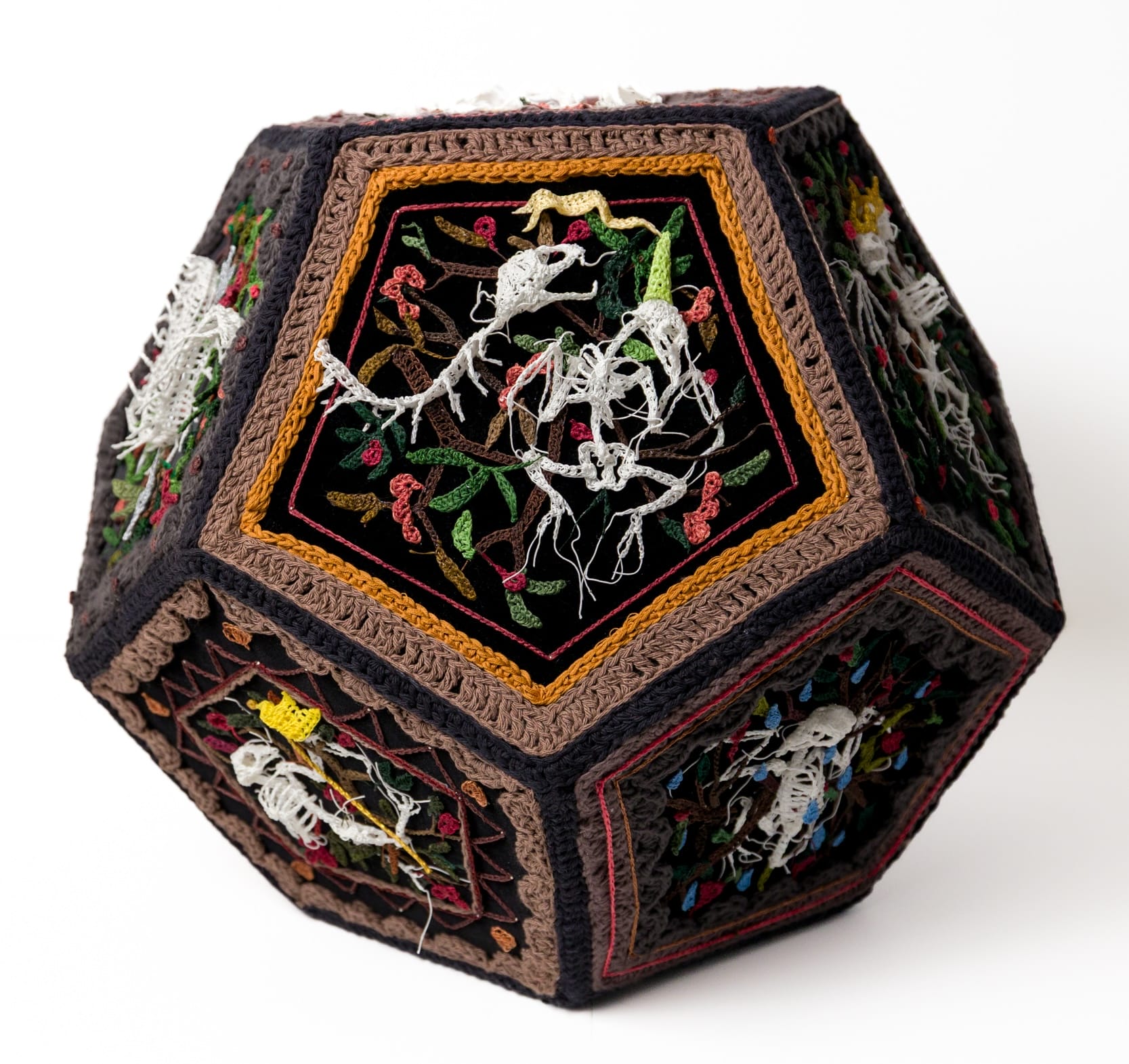 a geometric crocheted sculpture with details of skeletal animals
