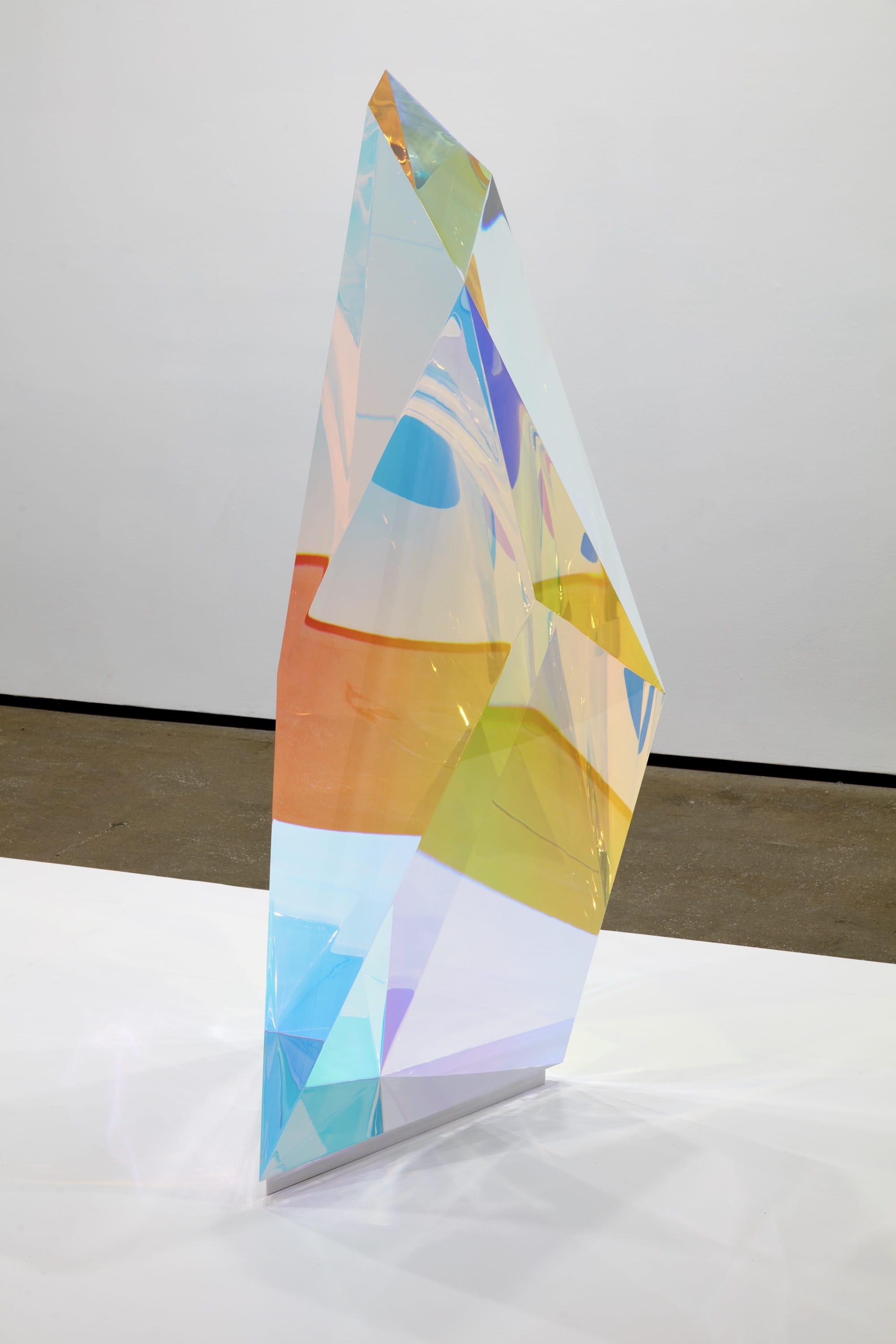 a sculpture by Mariko Mori of a clear, faceted chunk of acrylic with prismatic colors