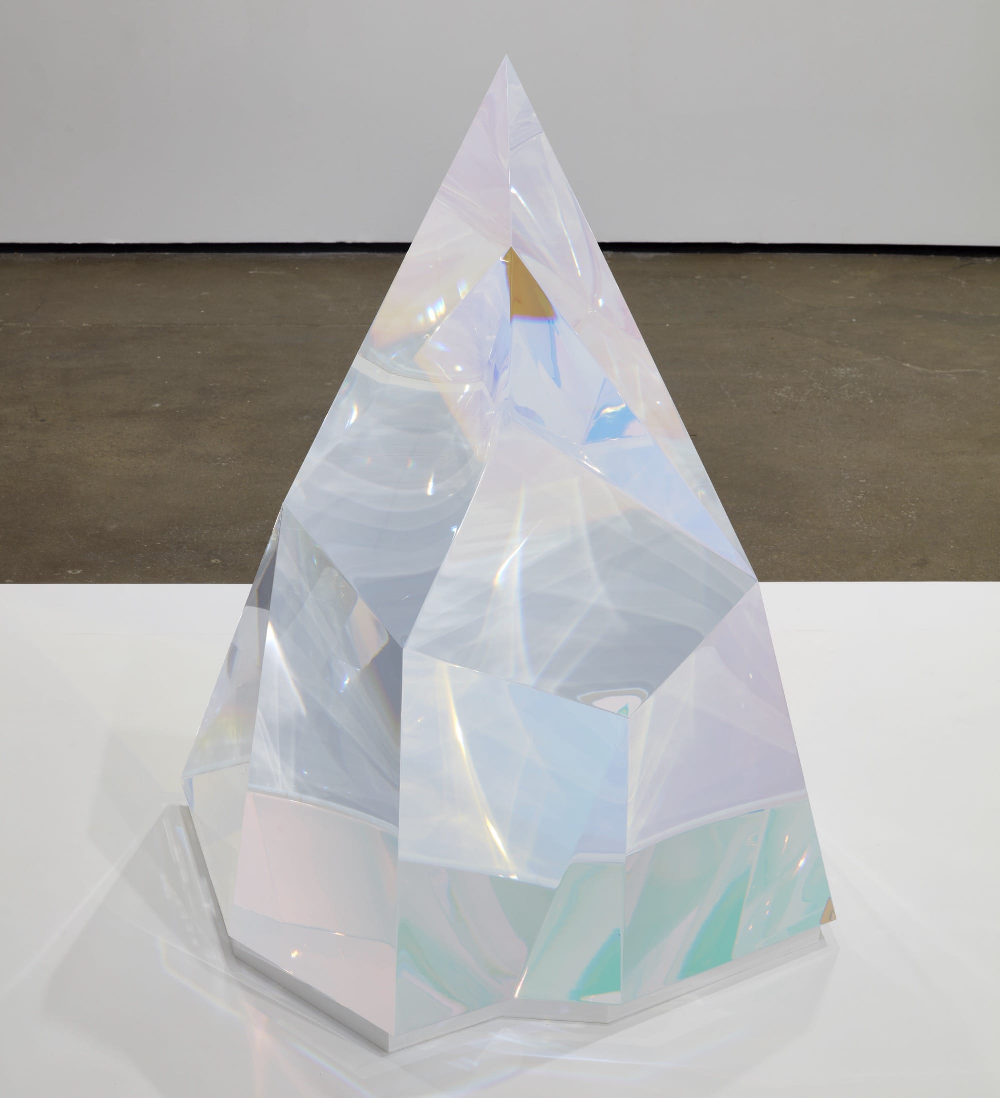 a sculpture by Mariko Mori of a clear, faceted chunk of acrylic with prismatic colors