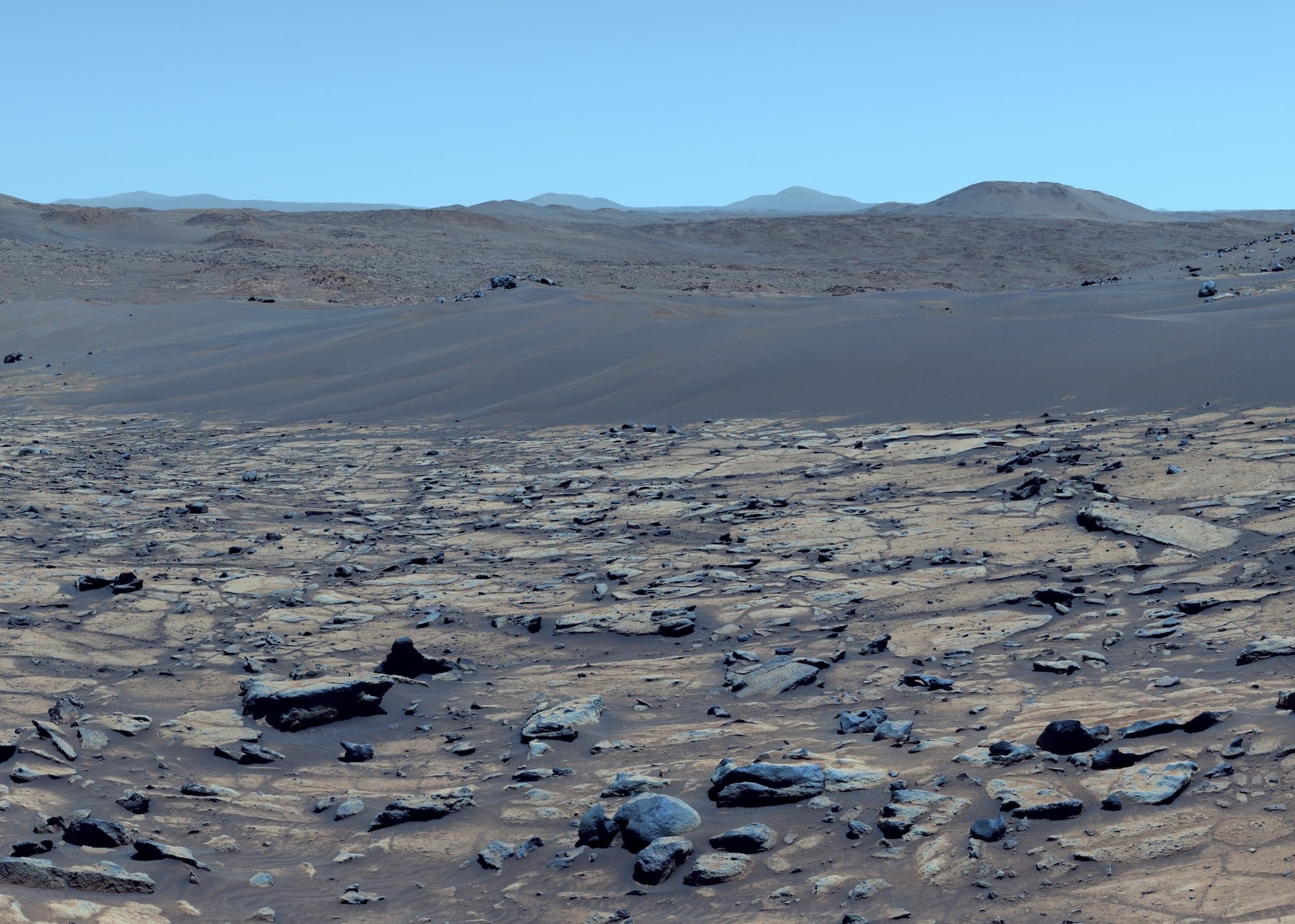 a color-enhanced photo of a Martian landscape that makes the red planet look more Earth-like