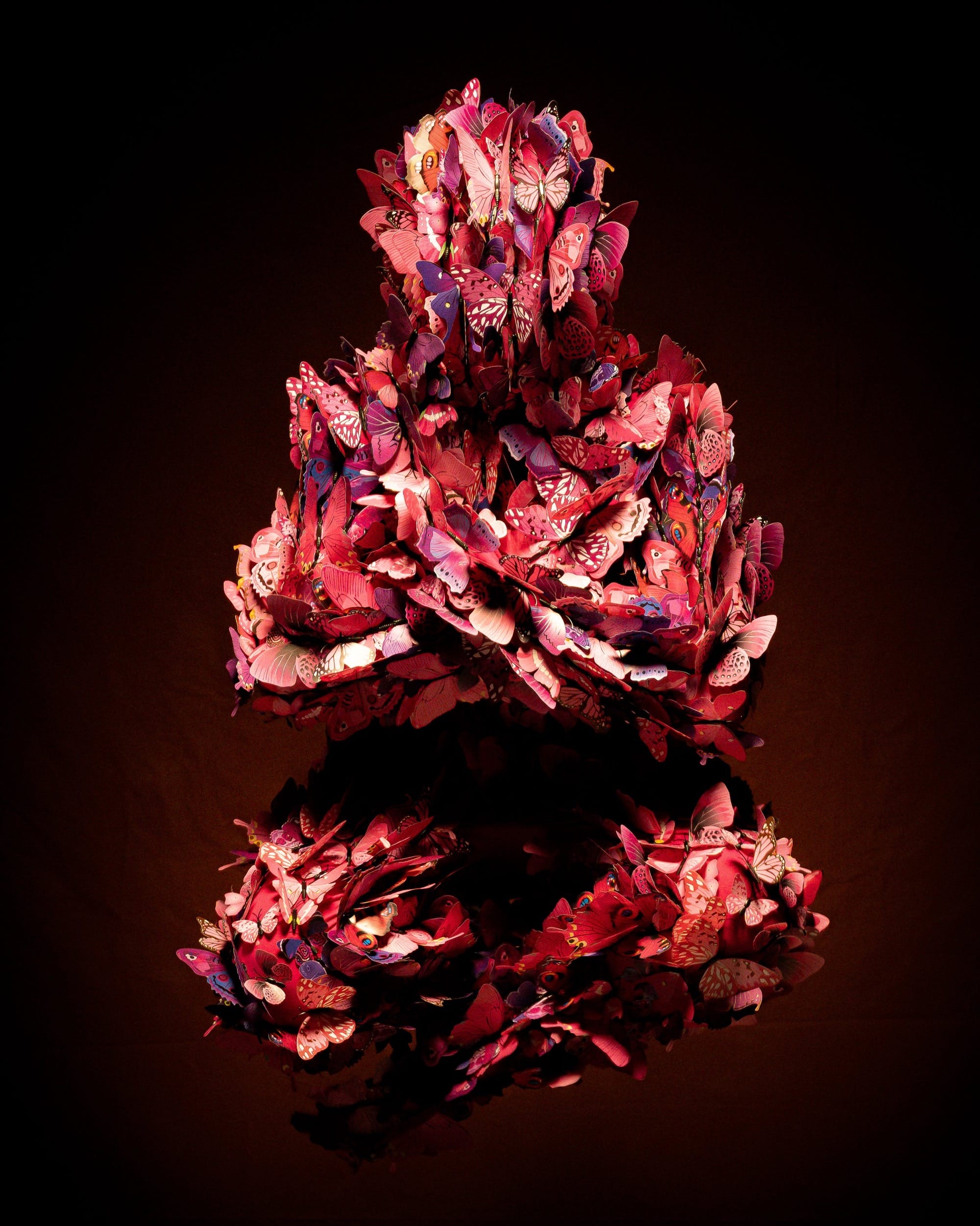 a costumed figure with an all-over outfit of purple and pink butterflies