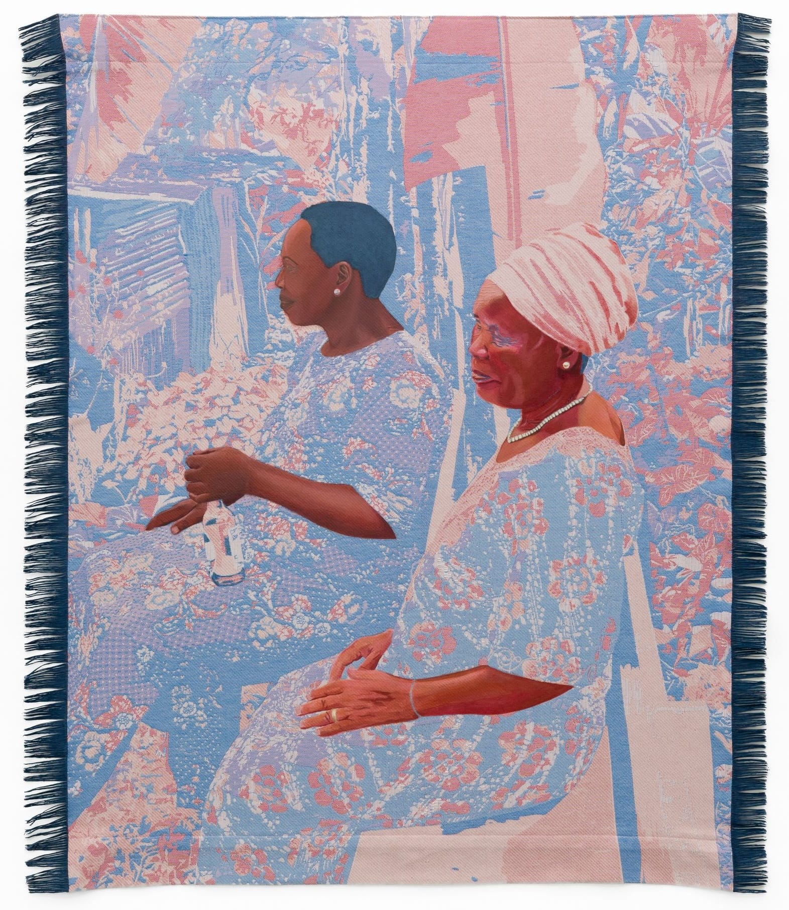 a woven Jacquard tapestry by Malaika Temba of two seated Black women wearing light-colored garments